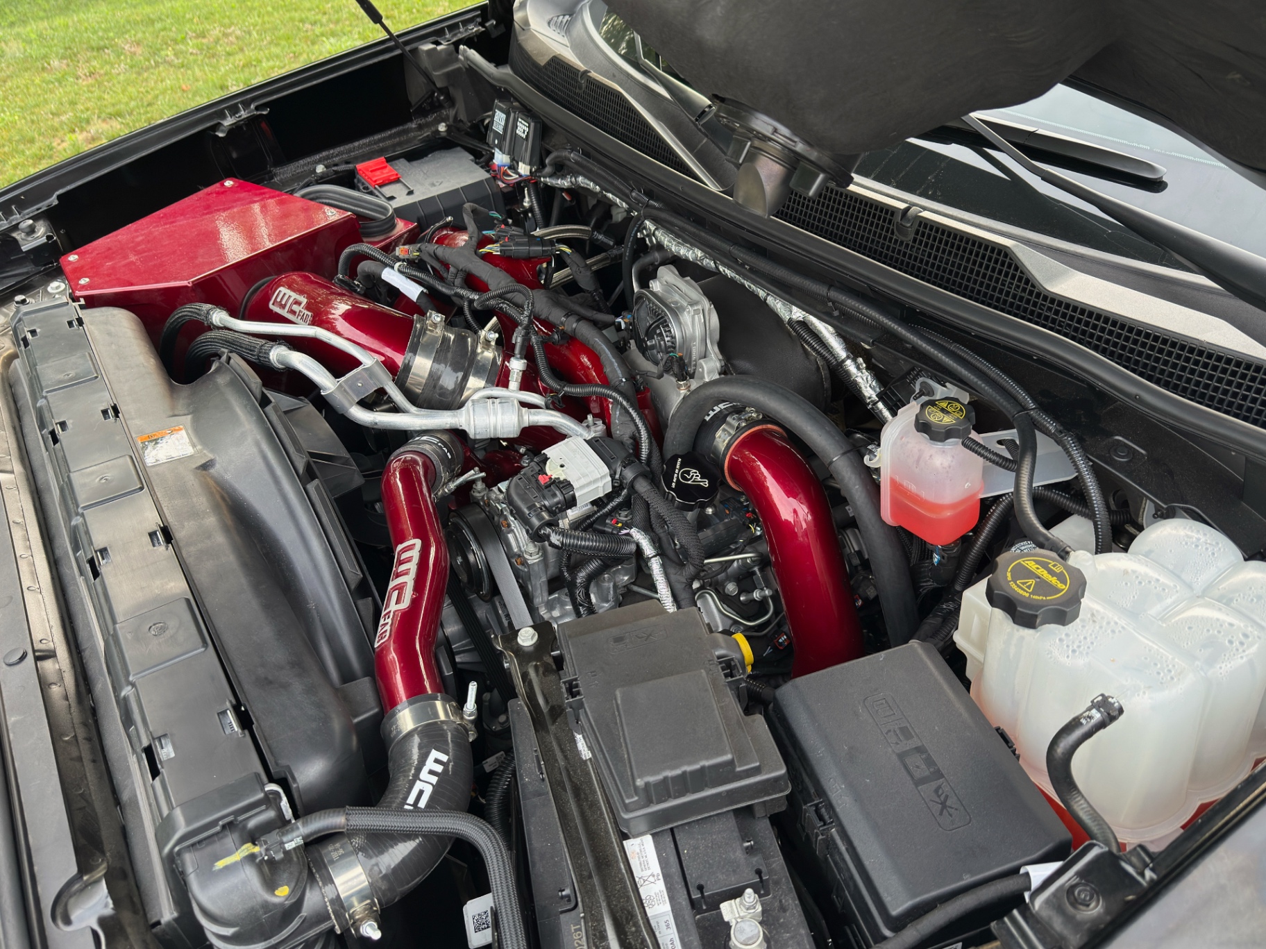 Red intake tubing and turbo on a customer L5P in the L&D bay